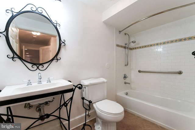 full bathroom featuring tile patterned flooring, tiled shower / bath, sink, and toilet