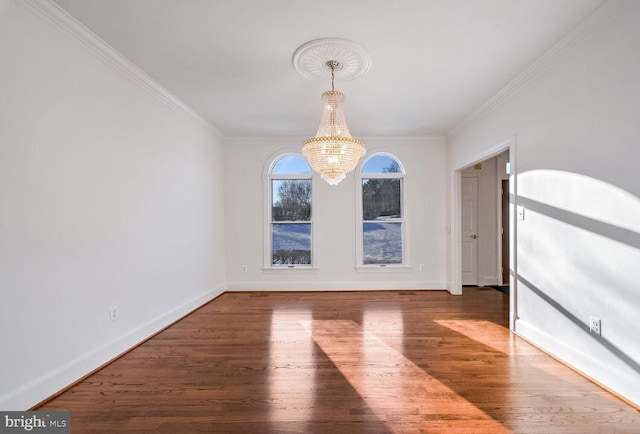 unfurnished dining area with an inviting chandelier, hardwood / wood-style flooring, and crown molding