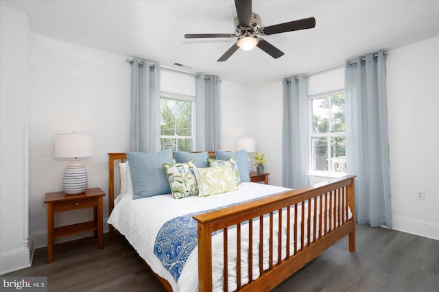 bedroom with ceiling fan and dark hardwood / wood-style flooring