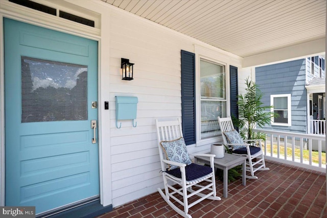 view of exterior entry with a porch