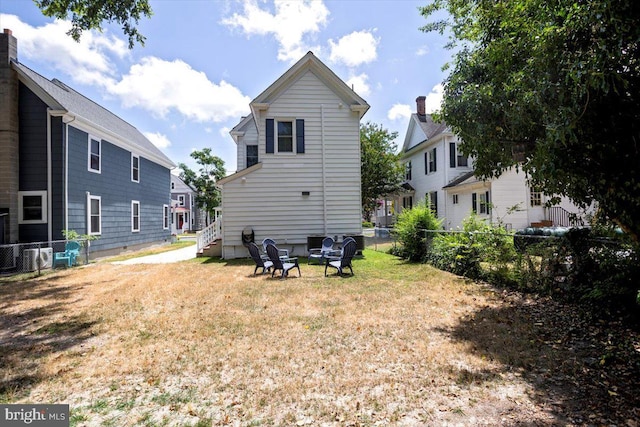 rear view of property with a yard