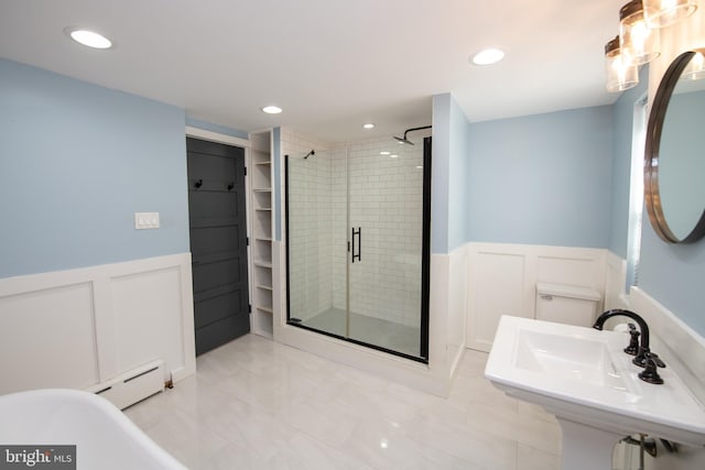 bathroom featuring a baseboard radiator, tile patterned floors, a shower with shower door, and sink