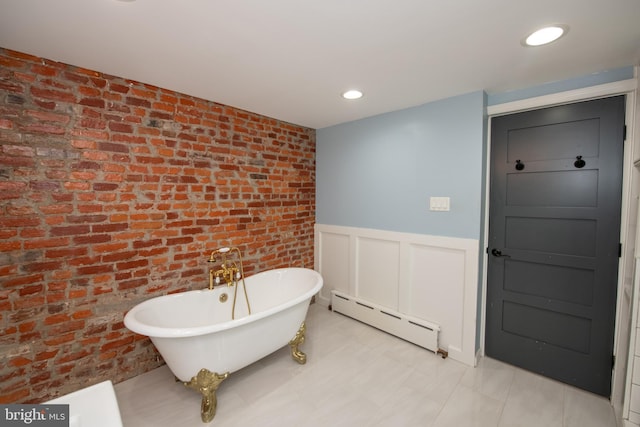 bathroom with a bathing tub and a baseboard heating unit