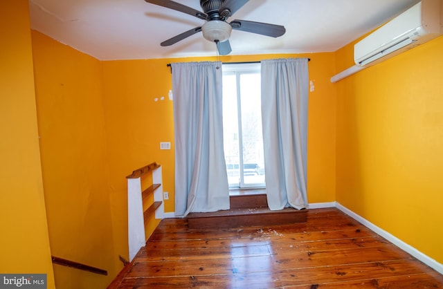 unfurnished room featuring ceiling fan, dark hardwood / wood-style floors, and a wall mounted AC