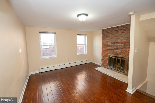 unfurnished living room featuring dark hardwood / wood-style flooring, a fireplace, and baseboard heating