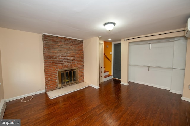 unfurnished living room with dark hardwood / wood-style flooring and a fireplace