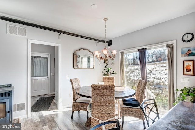 dining room featuring an inviting chandelier and light wood-type flooring