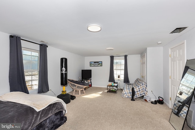 bedroom featuring light carpet