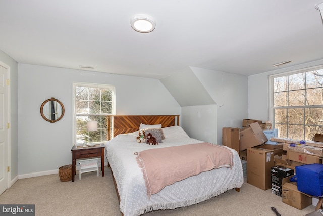 bedroom with light colored carpet and lofted ceiling