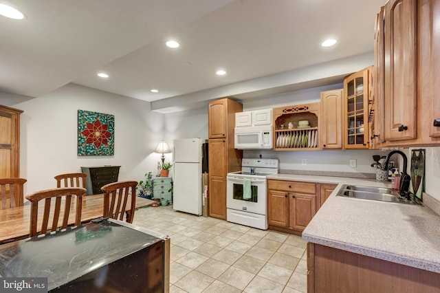 kitchen with sink, white appliances, and light tile patterned floors