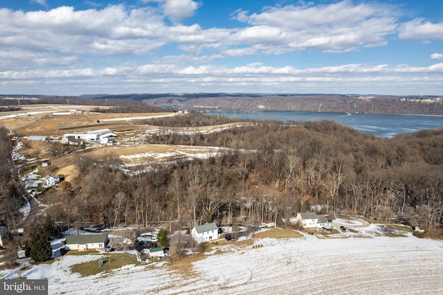 snowy aerial view featuring a water view