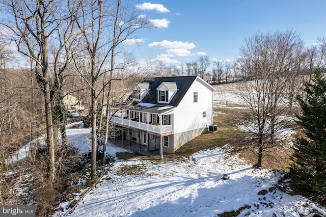 snow covered property featuring a sunroom