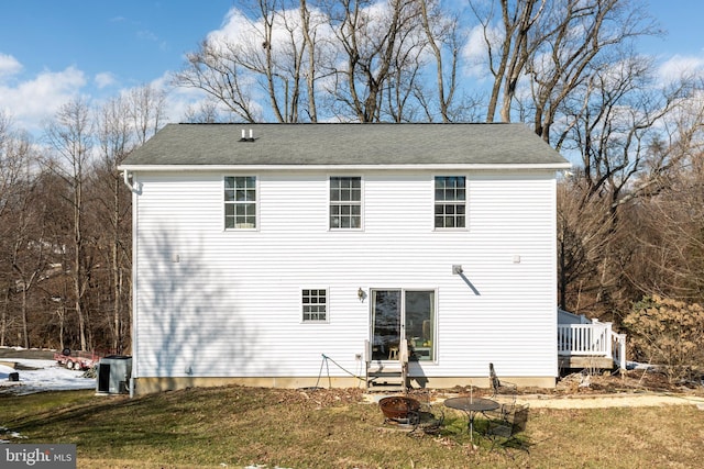 rear view of property with a lawn