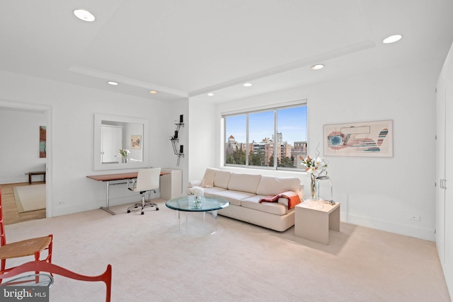 living room with light carpet and a tray ceiling