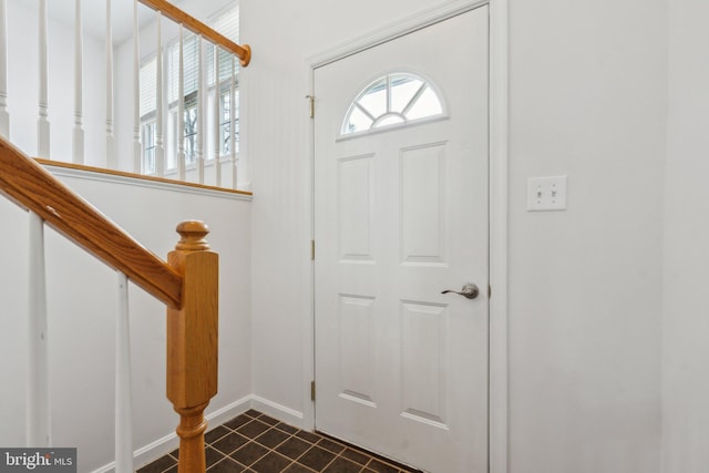 foyer with dark tile patterned flooring