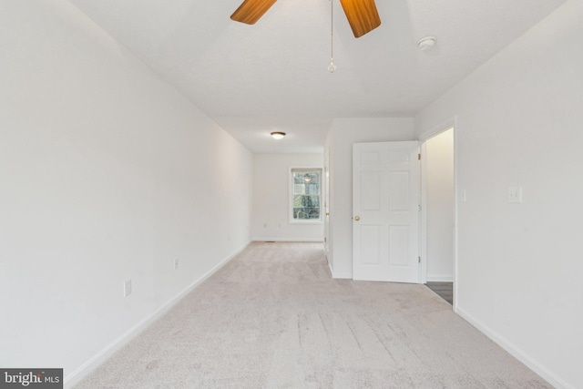 unfurnished room featuring light colored carpet and ceiling fan