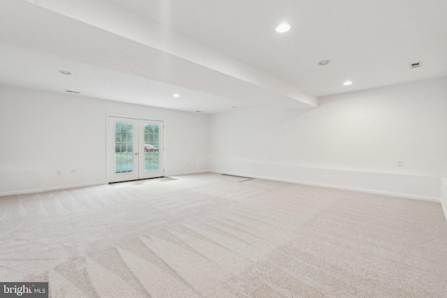 carpeted empty room featuring french doors