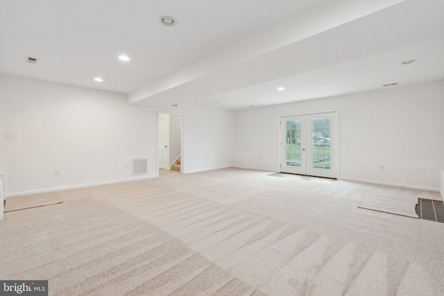 empty room with light colored carpet and french doors