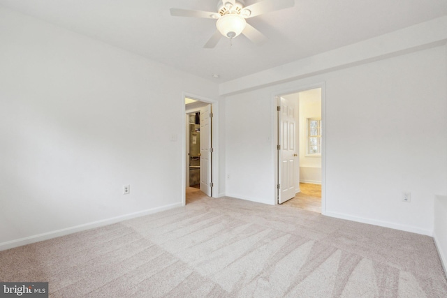 unfurnished bedroom with ensuite bathroom and light colored carpet