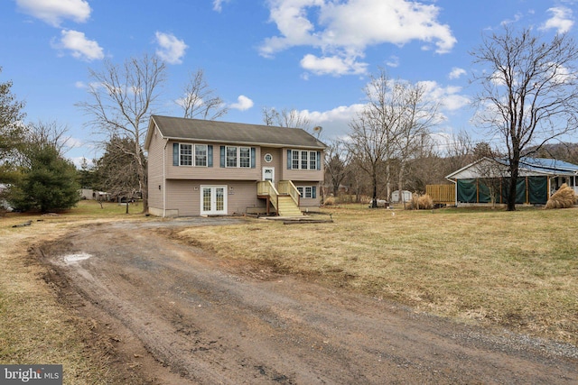 view of front of house with a front yard and french doors