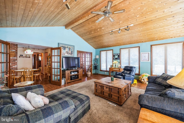 living room with rail lighting, beam ceiling, high vaulted ceiling, wooden ceiling, and french doors