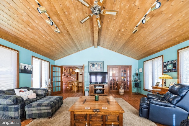 living room with wood ceiling, rail lighting, lofted ceiling with beams, and carpet