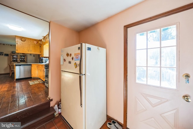 kitchen with dark wood-type flooring, a healthy amount of sunlight, and stainless steel appliances