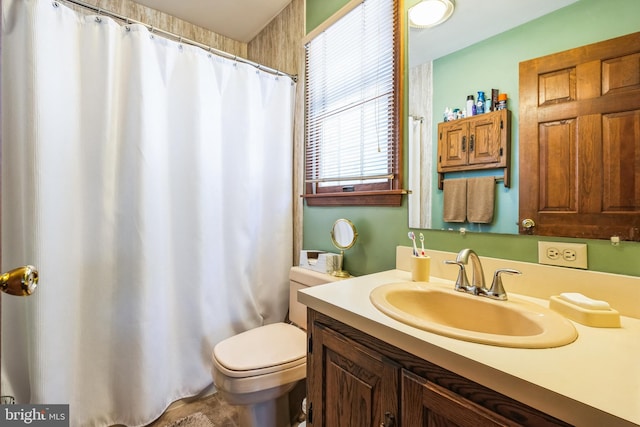 bathroom featuring vanity, walk in shower, and toilet