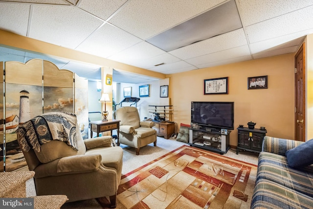 carpeted living room with a drop ceiling