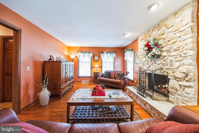 living room with hardwood / wood-style floors and a fireplace