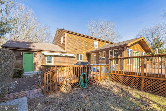 back of house with a wooden deck