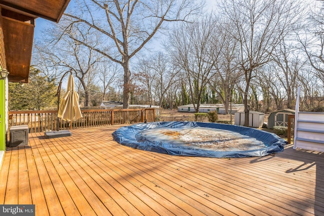 wooden deck featuring a storage unit