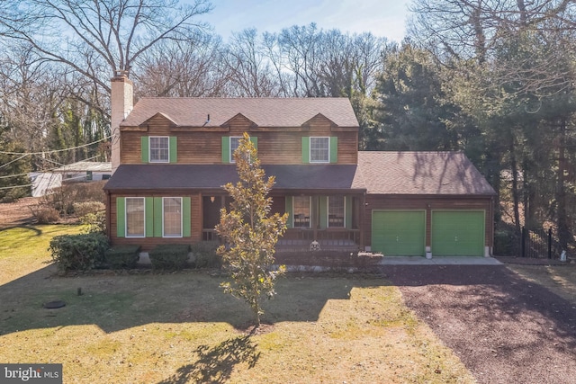 view of front of home featuring a garage and a front lawn