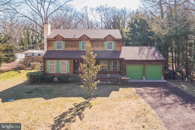 view of front of house with a garage and a front lawn