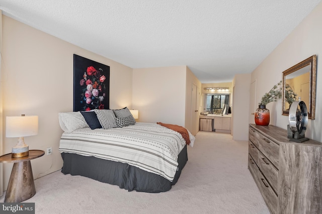 bedroom with light carpet, connected bathroom, and a textured ceiling