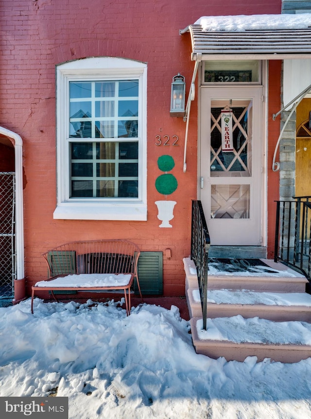 view of snow covered property entrance