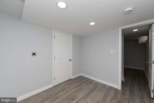 spare room featuring dark wood-type flooring