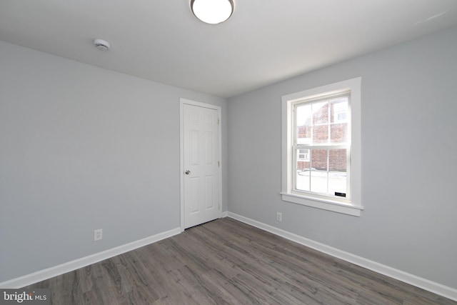 spare room featuring dark hardwood / wood-style flooring