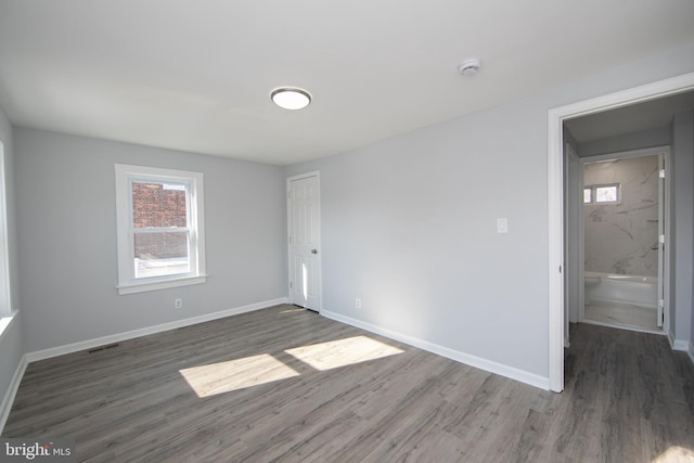 empty room featuring dark hardwood / wood-style flooring