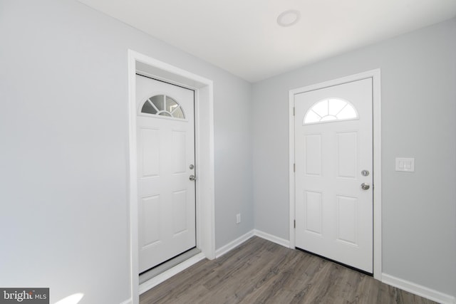 entryway with dark hardwood / wood-style flooring