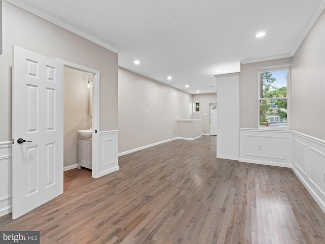 empty room with crown molding and wood-type flooring