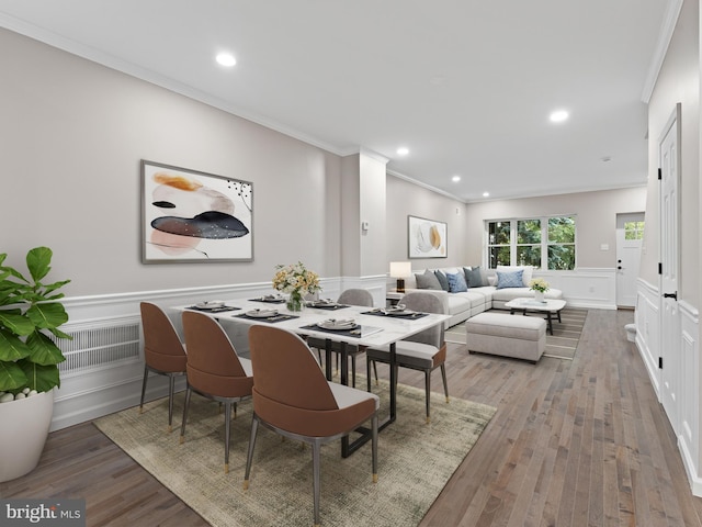 dining area featuring light hardwood / wood-style flooring and ornamental molding