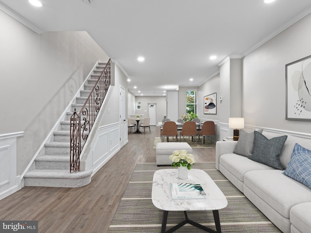 living room with crown molding and hardwood / wood-style flooring