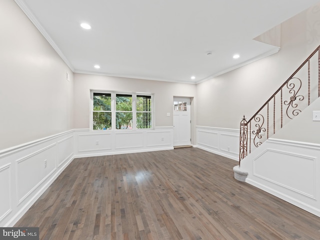 unfurnished living room with dark wood-type flooring and ornamental molding