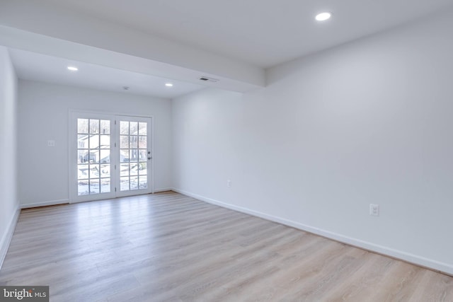 empty room with light hardwood / wood-style flooring