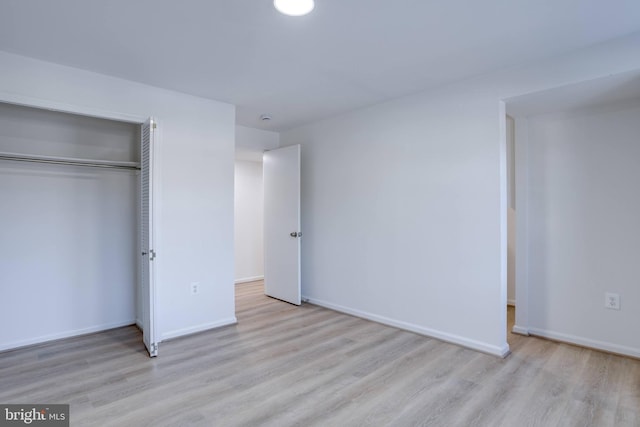 unfurnished bedroom featuring a closet and light hardwood / wood-style flooring