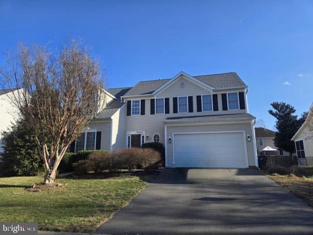 view of front of house with a garage and a front yard