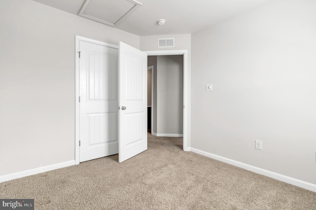 unfurnished bedroom featuring light carpet