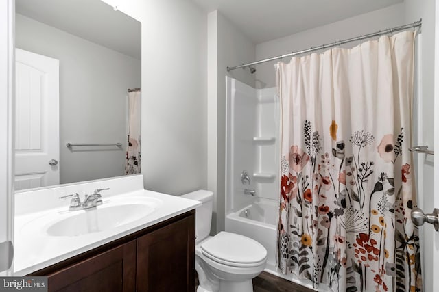 full bathroom featuring shower / bath combination with curtain, vanity, and toilet