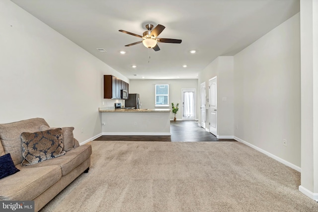 living room with carpet floors and ceiling fan